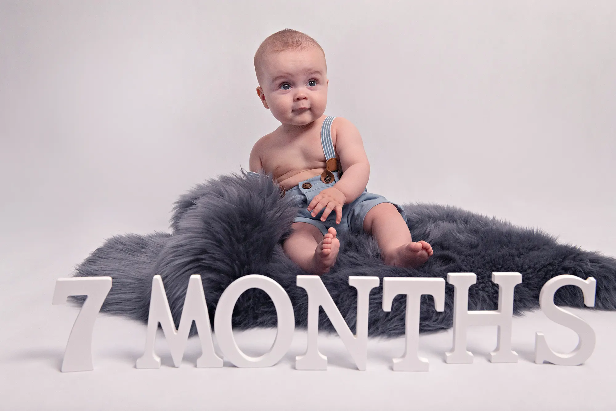 Soothing baby sleeping on cloud prop at Sky Portraits, St Leonards, Sydney - creative newborn photography