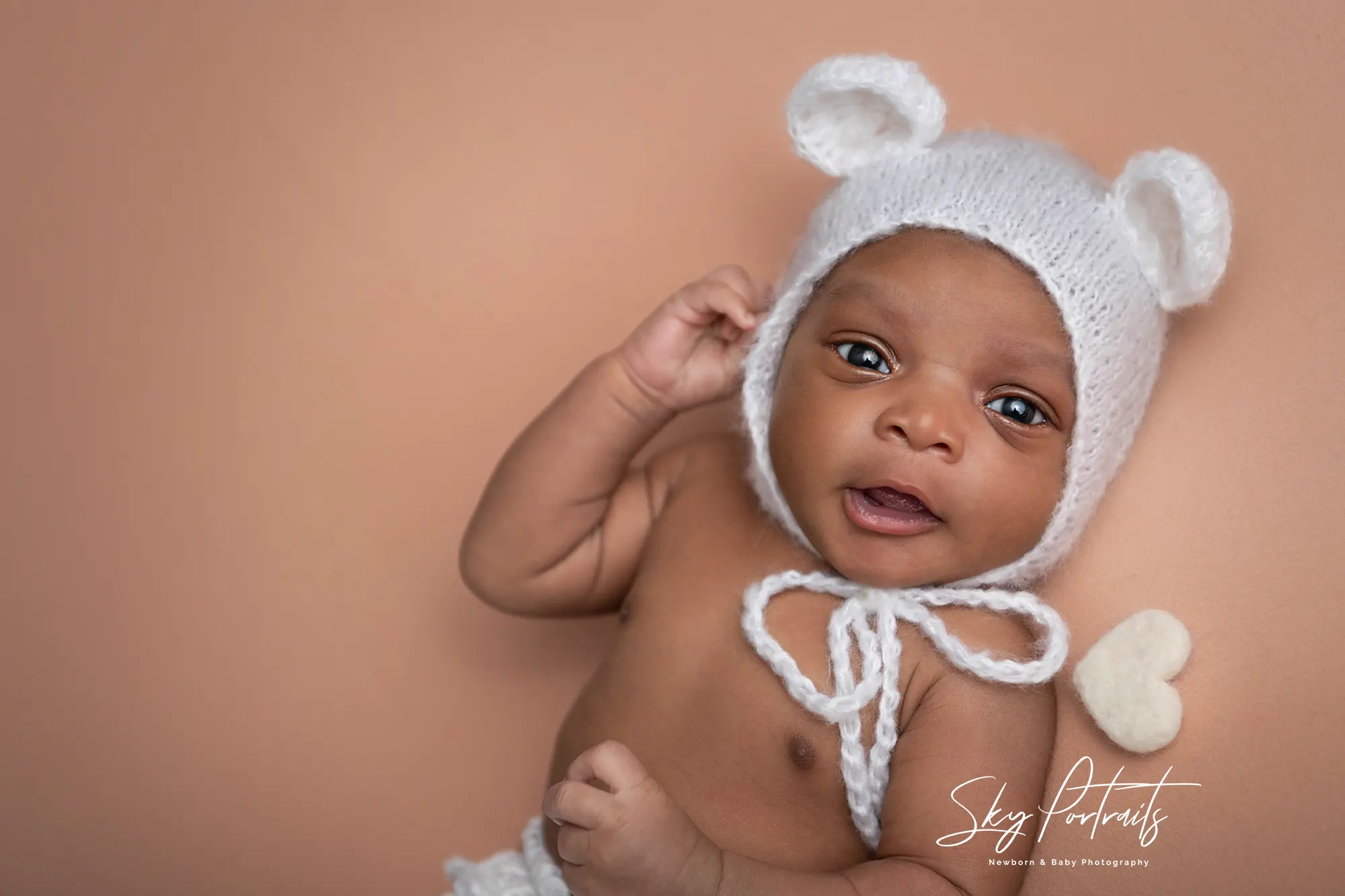 Newborn baby girl with floral headband at Sky Portraits, Sydney - baby photographer