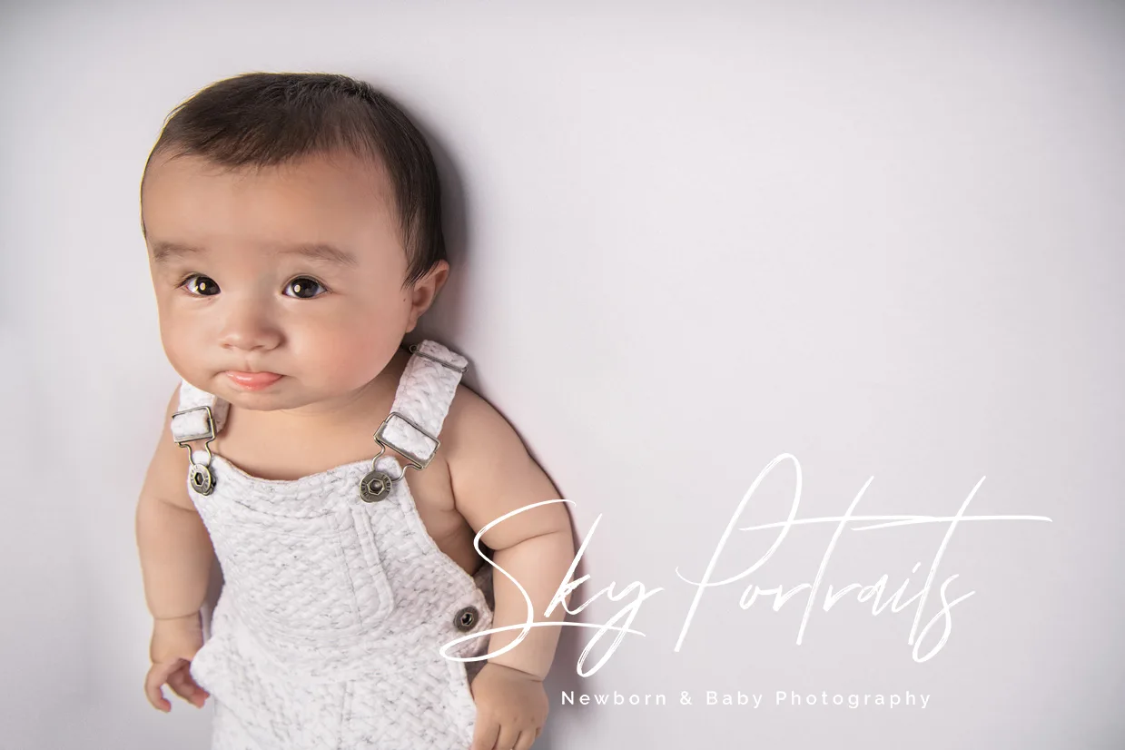 Newborn baby girl with floral headband at Sky Portraits, Sydney - baby photographer