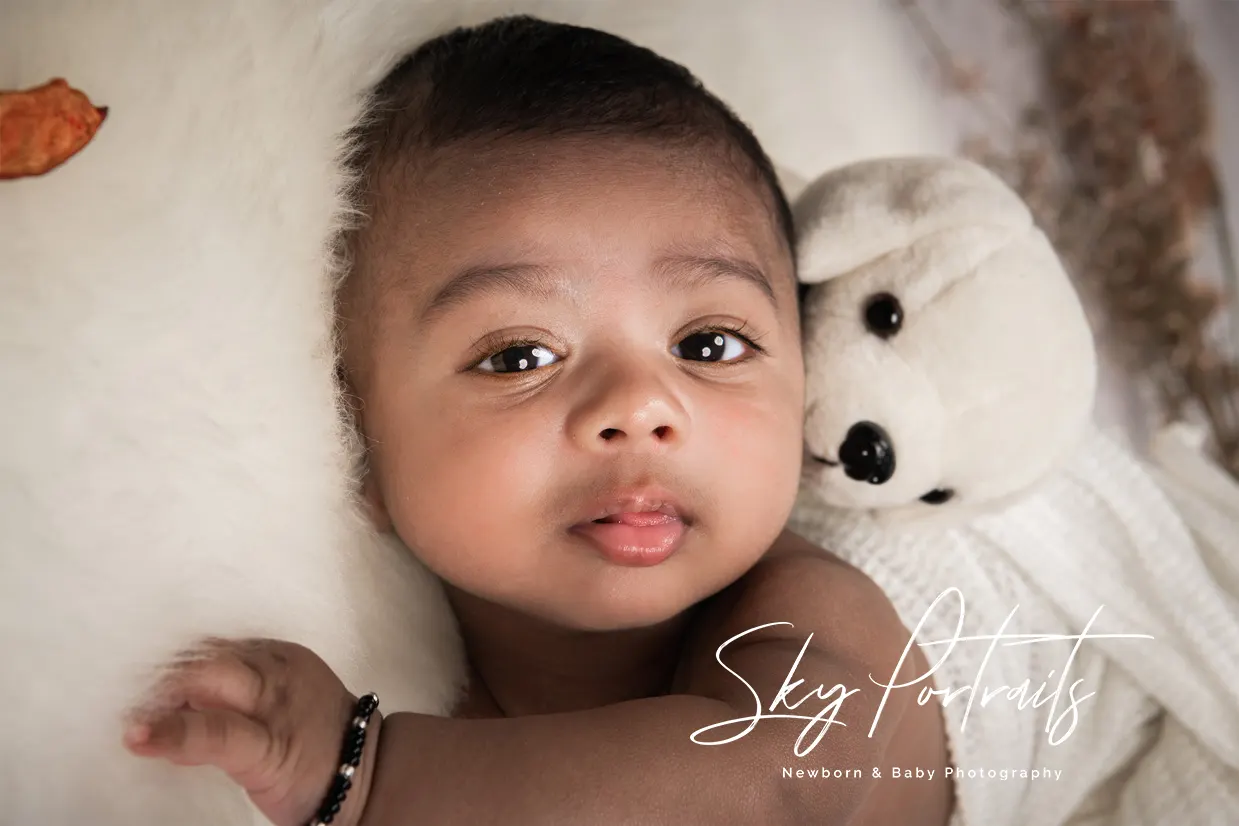 Peaceful newborn resting on fur throw at Sky Portraits Studio, Sydney - newborn photography