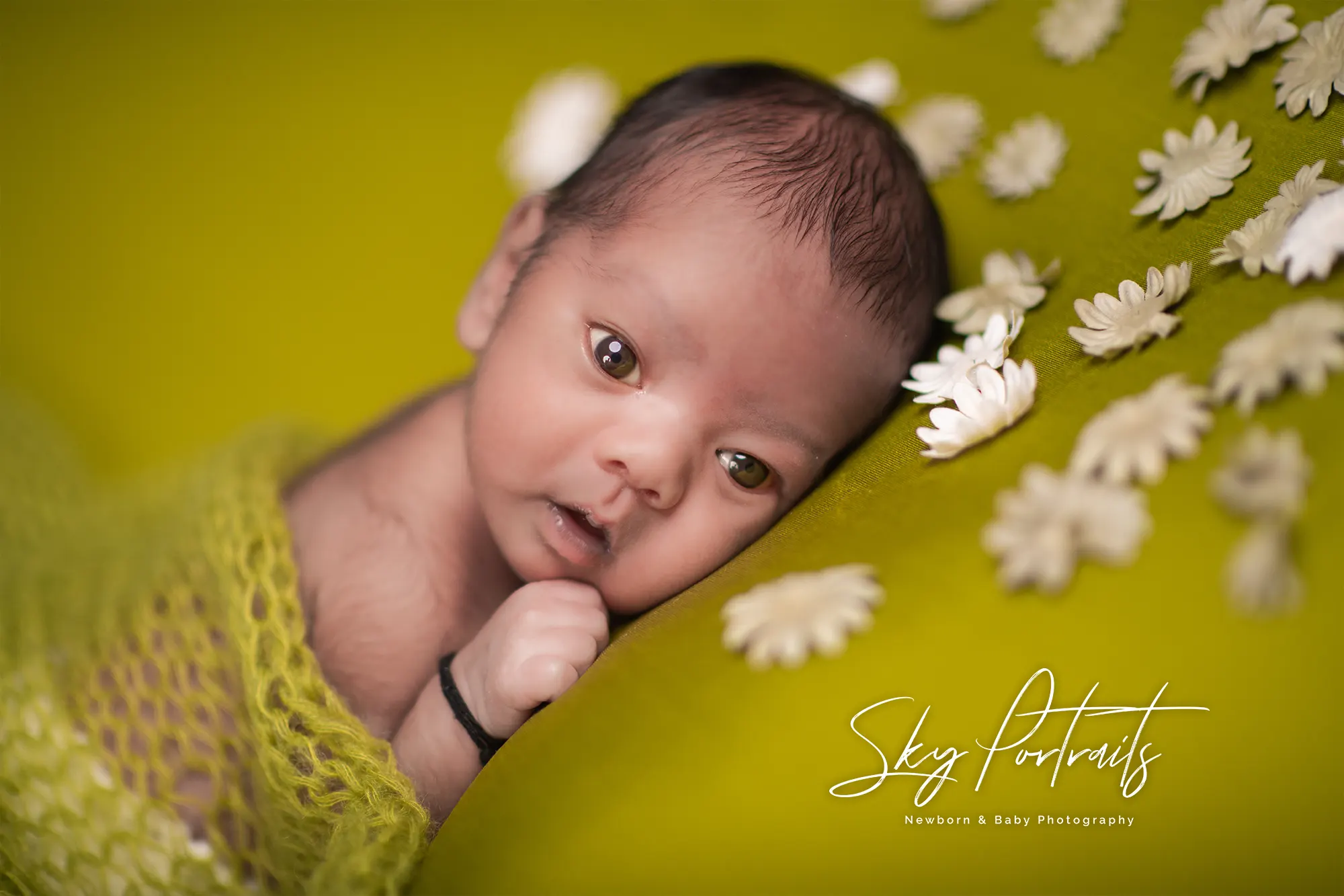 Peaceful newborn resting on fur throw at Sky Portraits Studio, Sydney - newborn photography