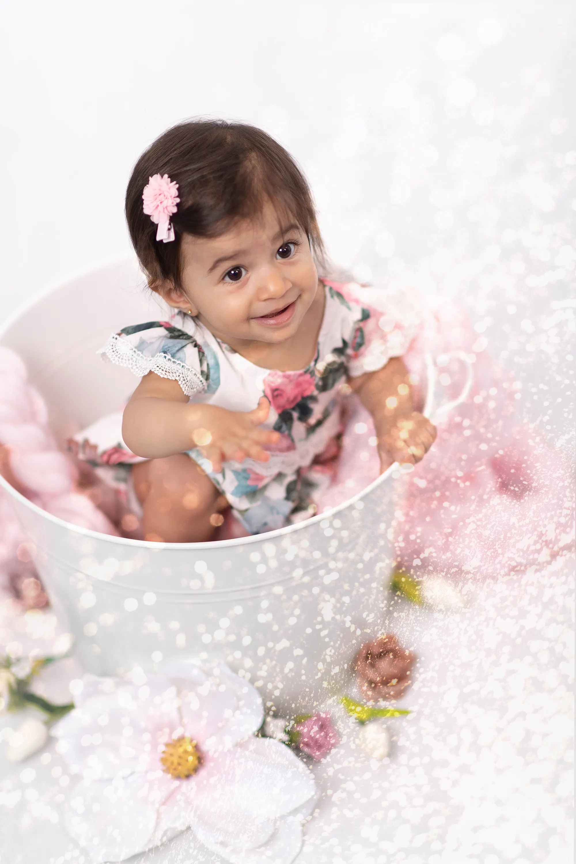 Toddler smiling at the camera during a sitter session at Sky Portraits