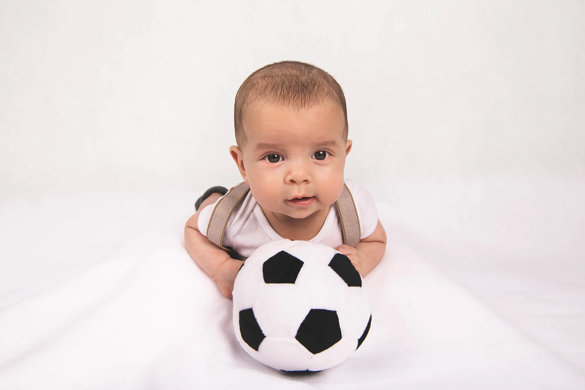 Charlie Patrier with his wife and baby, enjoying a serene moment at Sky Portraits studio